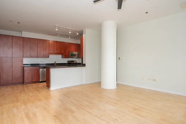 a kitchen with stainless steel appliances a refrigerator and a stove top oven