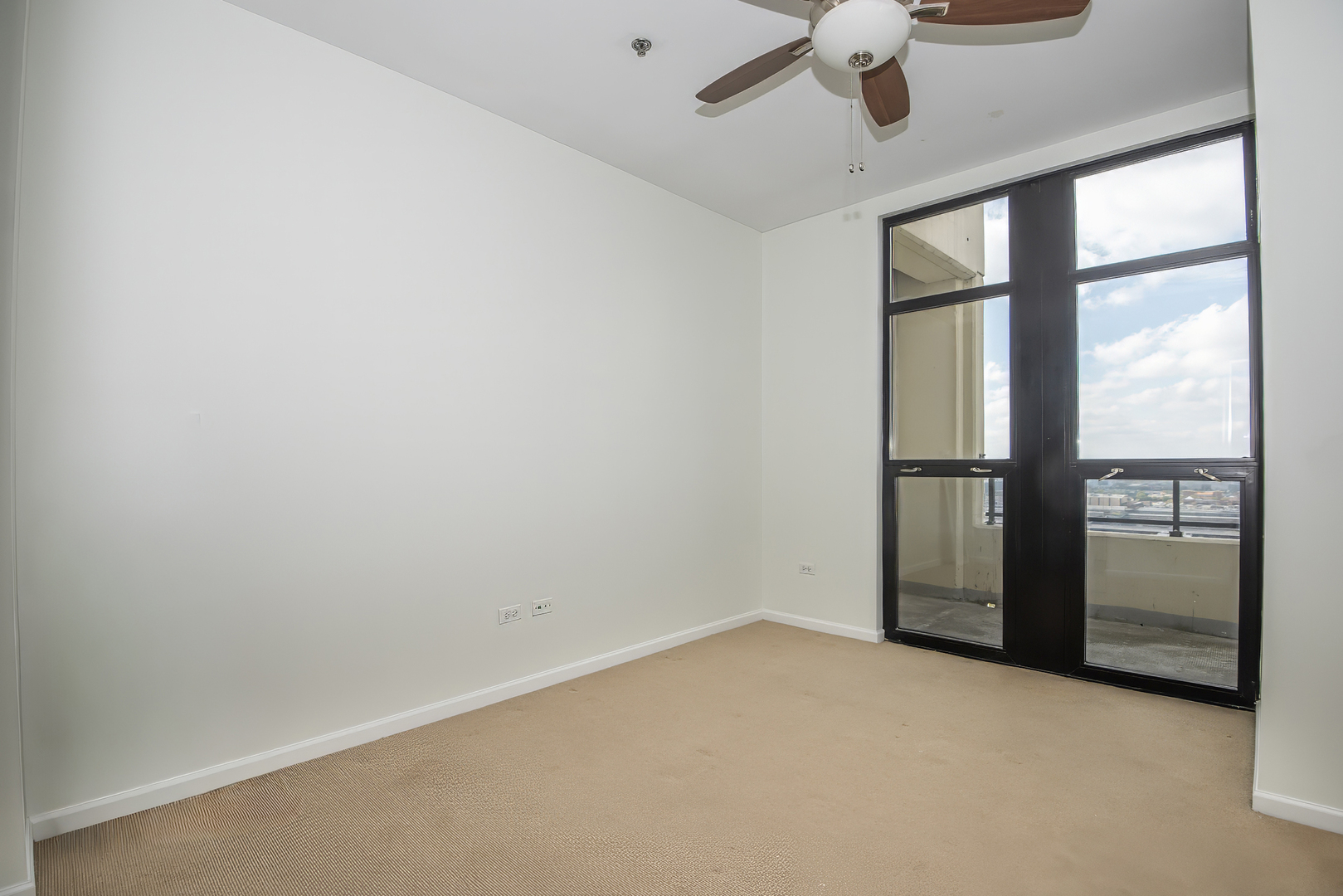 1255 South State Street, Unit 1902 Chicago, IL 60605 - Photo 24 of 33 an empty room with a window and a ceiling fan