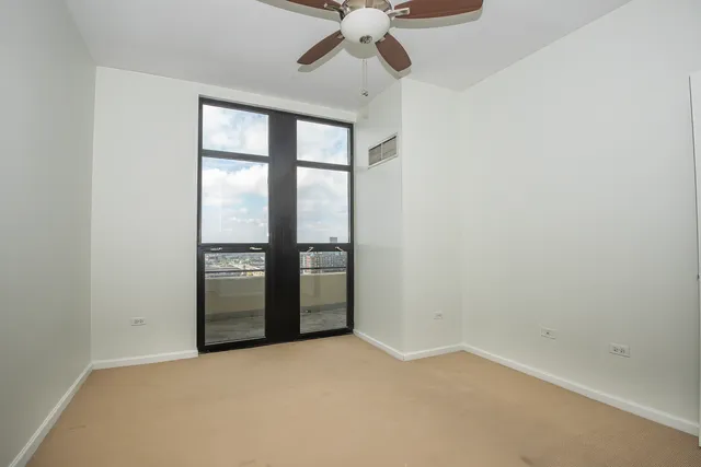 an empty room with a empty space and a ceiling fan