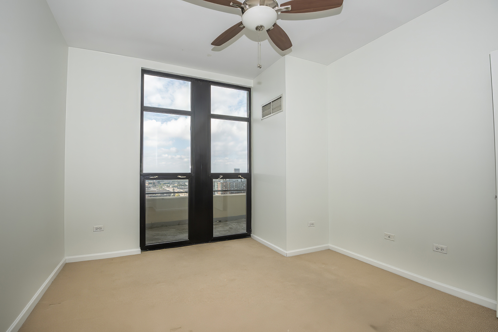 1255 South State Street, Unit 1902 Chicago, IL 60605 - Photo 25 of 33 an empty room with a empty space and a ceiling fan