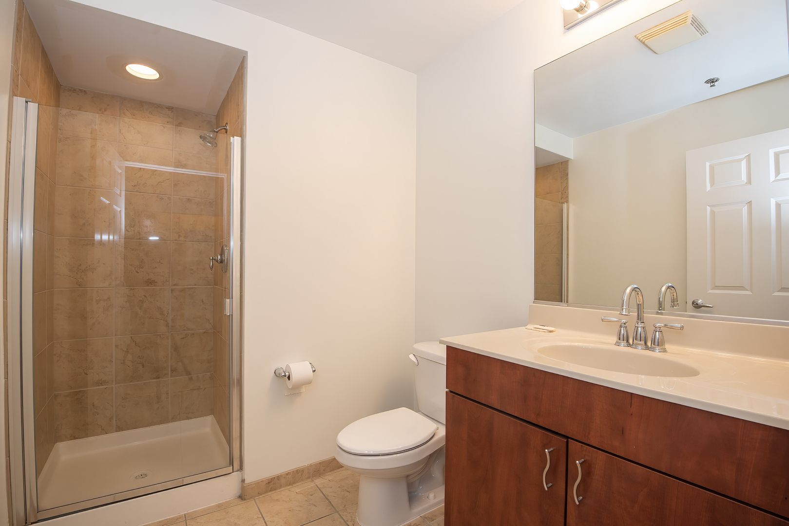 1255 South State Street, Unit 1902 Chicago, IL 60605 - Photo 26 of 33 a bathroom with a sink a toilet a mirror and shower