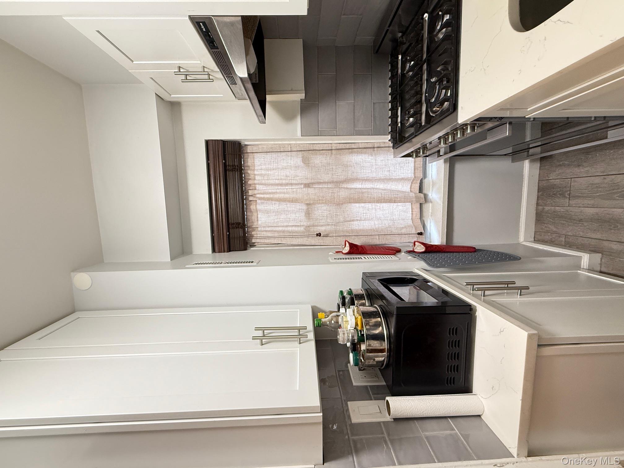67-40 Yellowstone Boulevard, Unit 2O Queens, NY 11375 - Photo 6 of 12 a kitchen with a stove and a sink
