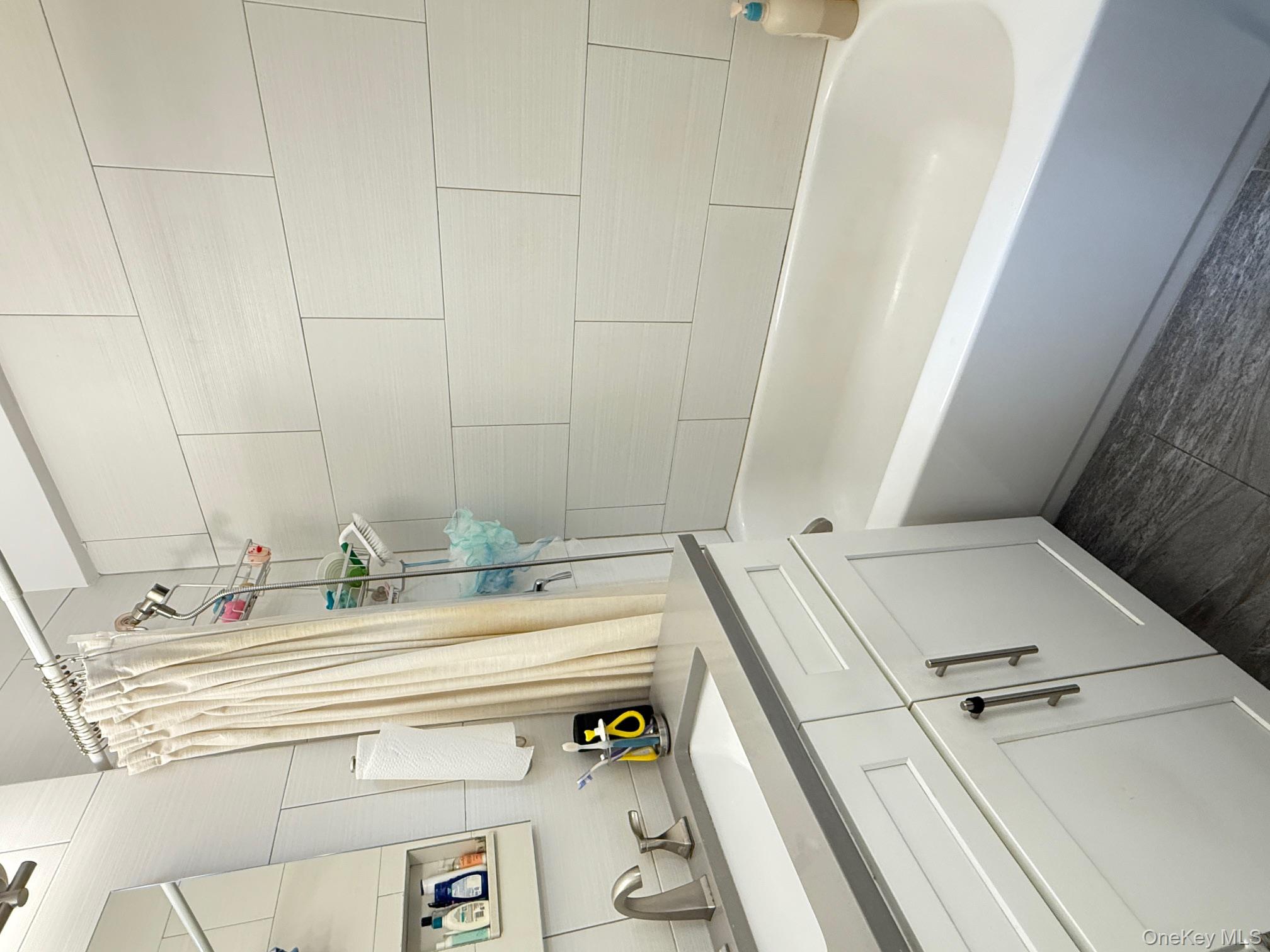 67-40 Yellowstone Boulevard, Unit 2O Queens, NY 11375 - Photo 8 of 12 a bathroom with a sink and a bathtub