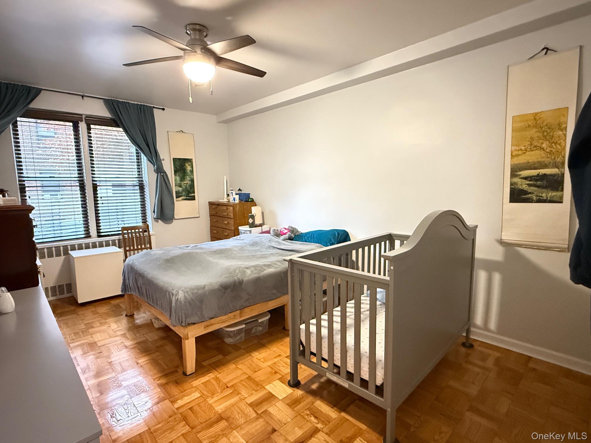 67-40 Yellowstone Boulevard, Unit 2O Queens, NY 11375 - Photo 9 of 12 a bedroom with furniture and a large window