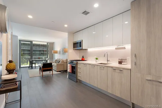 a kitchen with a sink and living room