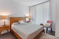 a bedroom with a bed and a chair