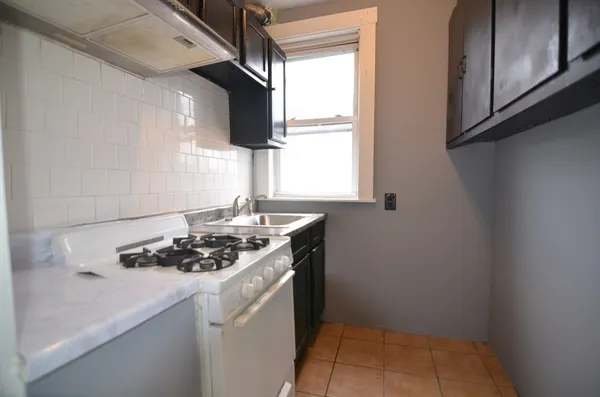a kitchen that has a sink and a stove