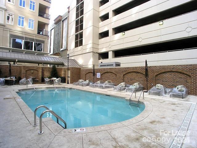 230 South Tryon Street Charlotte, NC 28281 - Photo 5 of 12 a view of a swimming pool with a lounge chairs