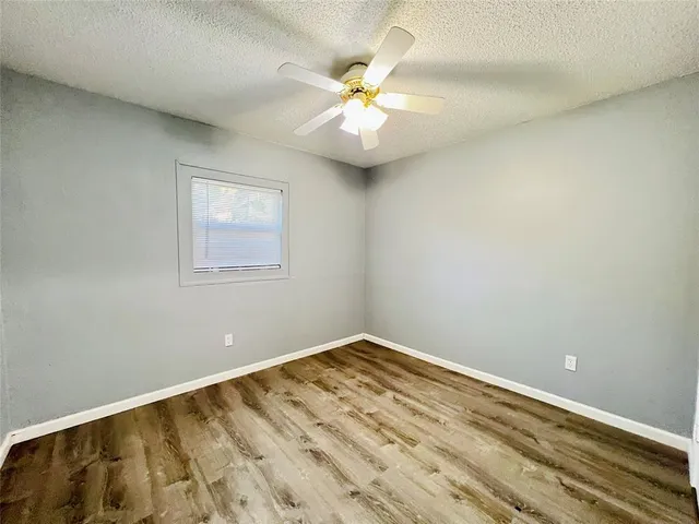 a bathroom with a granite countertop sink and a toilet