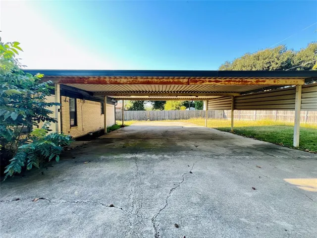 a view of a house with backyard and a trees