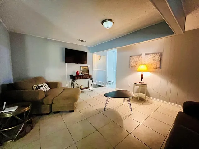 a living room with furniture and a lamp