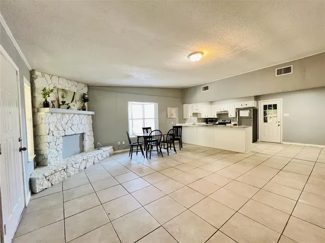 a kitchen with a table and chairs