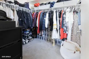 a view of walk in closet with clothes