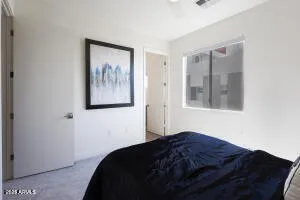 a bedroom with a bed and a painting on the wall