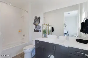 a bathroom with a sink a toilet and bathtub