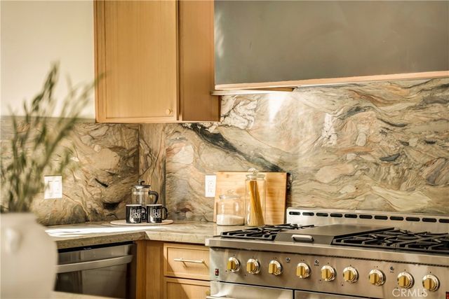a view of a kitchen with granite countertop a sink and a stove