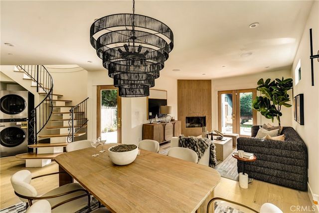 a living room with fireplace furniture and a chandelier