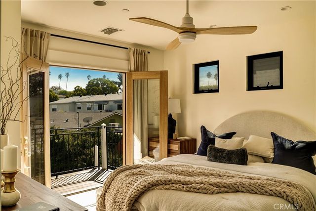 a bedroom with a bed and a painting on the wall