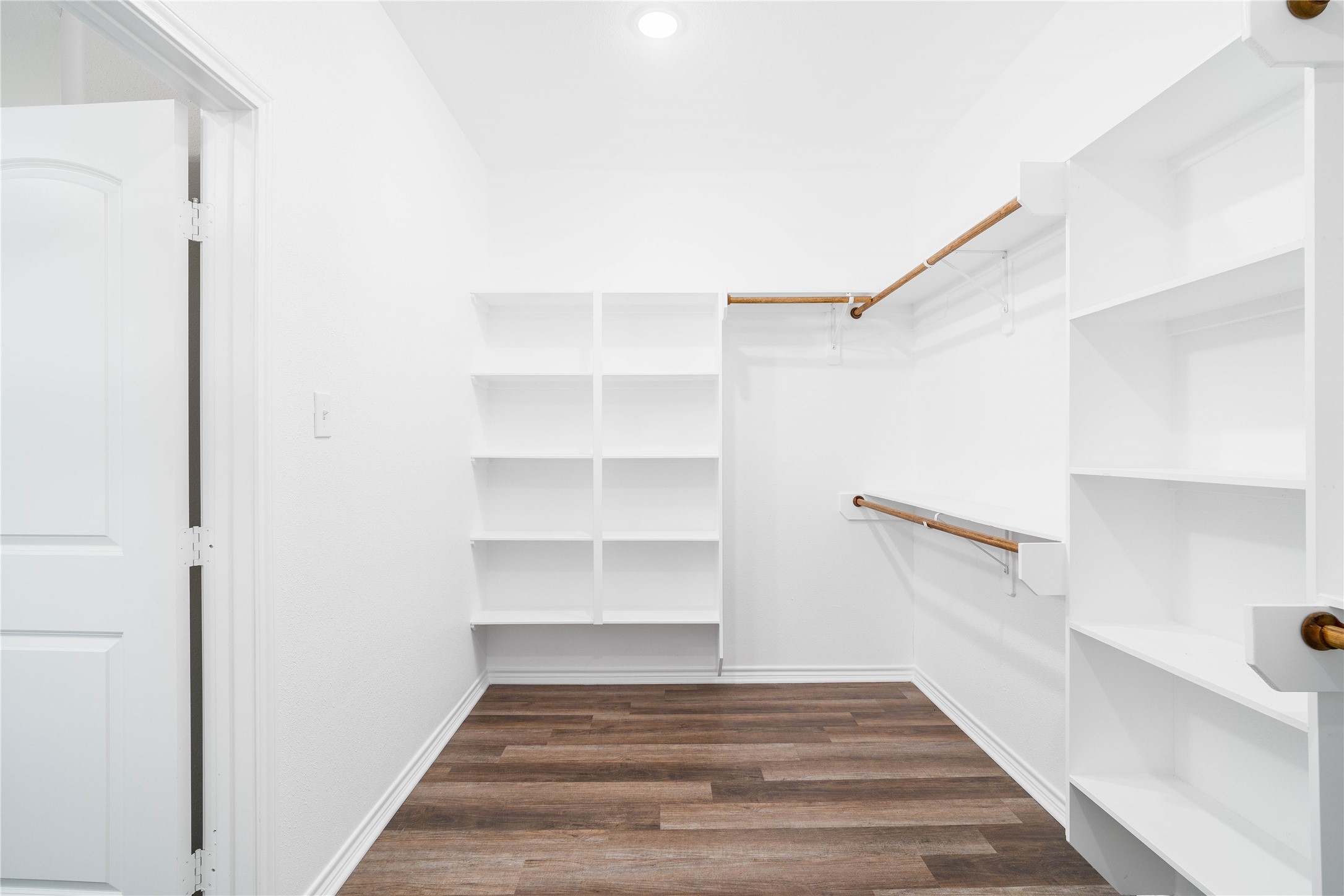 231 McCormick Street Columbus, TX 78934 - Photo 17 of 27 Walk-In Closet – Large walk-in closet with built-in shelving and hanging space for organized storage.
