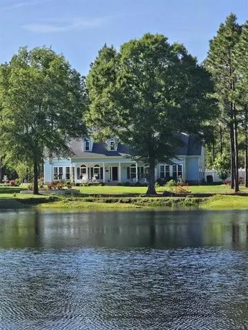 a view of swimming pool with outdoor seating and yard