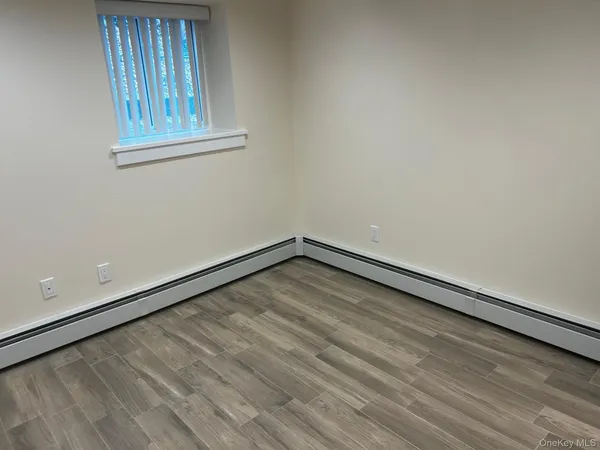 a view of an empty room and wooden floor