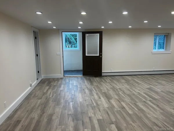 a view of an empty room with wooden floor
