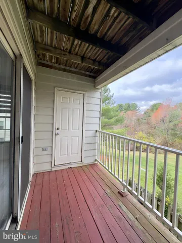 a view of a balcony with wooden floor