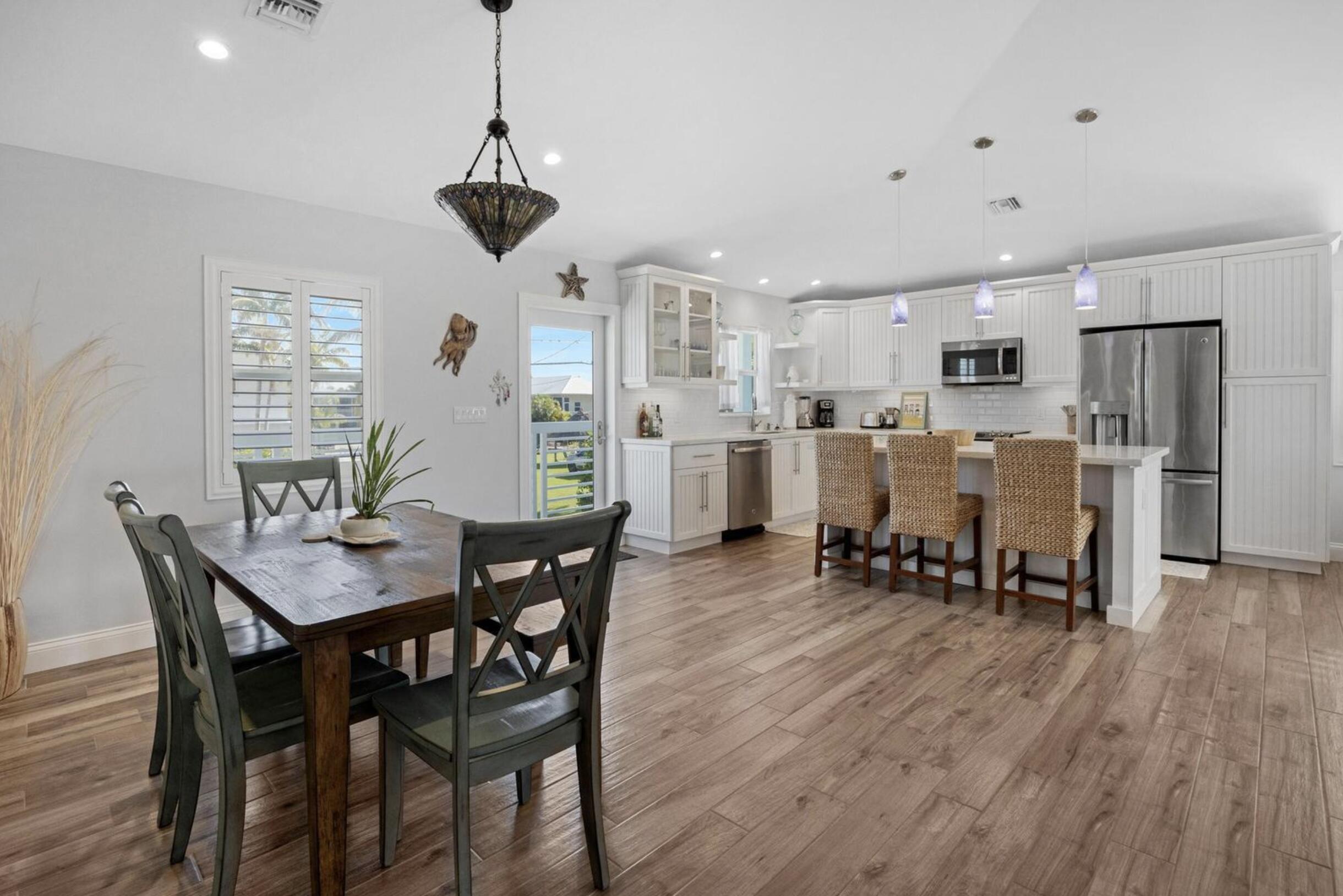 102 Venetian Drive Islamorada, FL 33036 - Photo 12 of 29 a view of a dining room with furniture and wooden floor