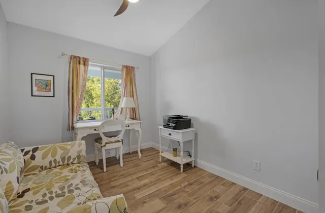 a bedroom with a bed a table and a chandelier