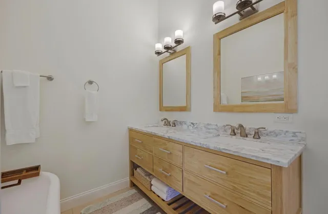 a bathroom with a tub sink and mirror