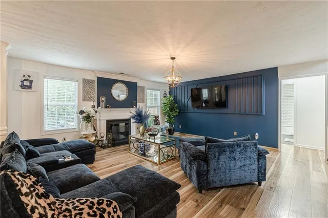 a living room with furniture a fireplace and a flat screen tv