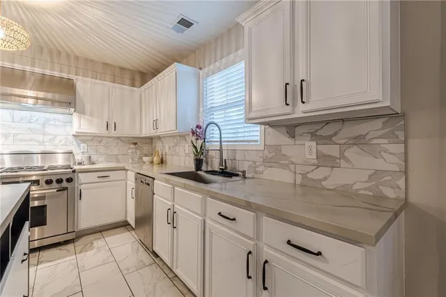 a kitchen with white cabinets and white appliances
