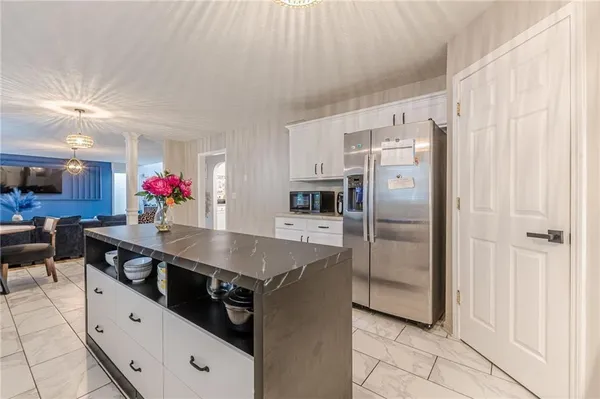 a kitchen with stainless steel appliances a sink and a refrigerator