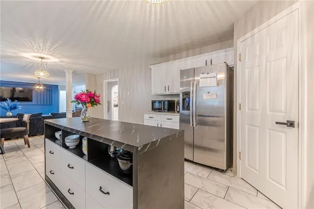 a kitchen with stainless steel appliances a sink and a refrigerator