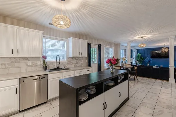 a kitchen with granite countertop a sink cabinets and window