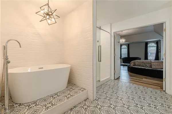 a bathroom with a bathtub and a shower