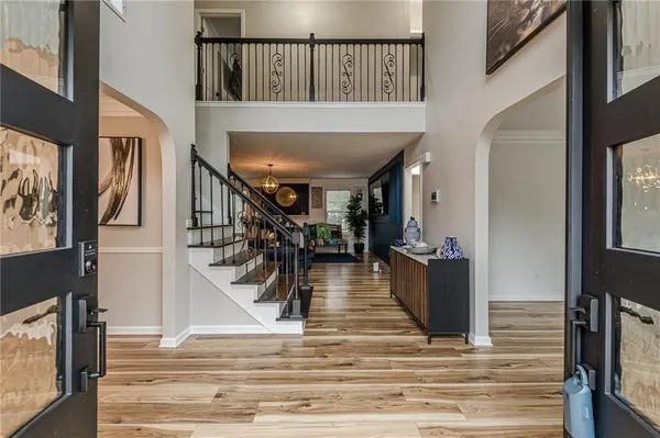 a view of entryway and hall with wooden floor