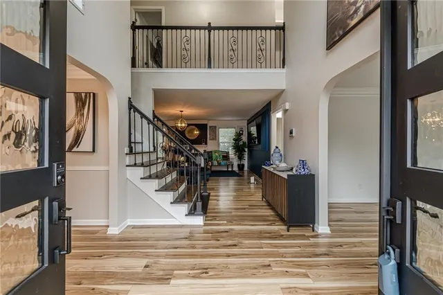 a view of entryway and hall with wooden floor