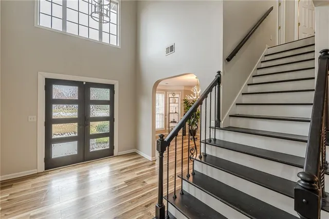 a view of entryway with wooden floor and stairs