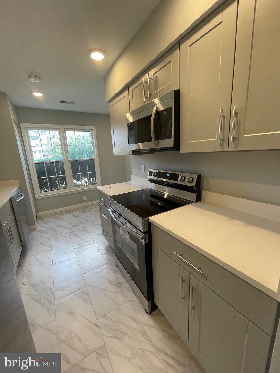 124 Andrew Place Sterling, VA 20164 - Photo 13 of 70 a kitchen with a sink a stove and cabinets