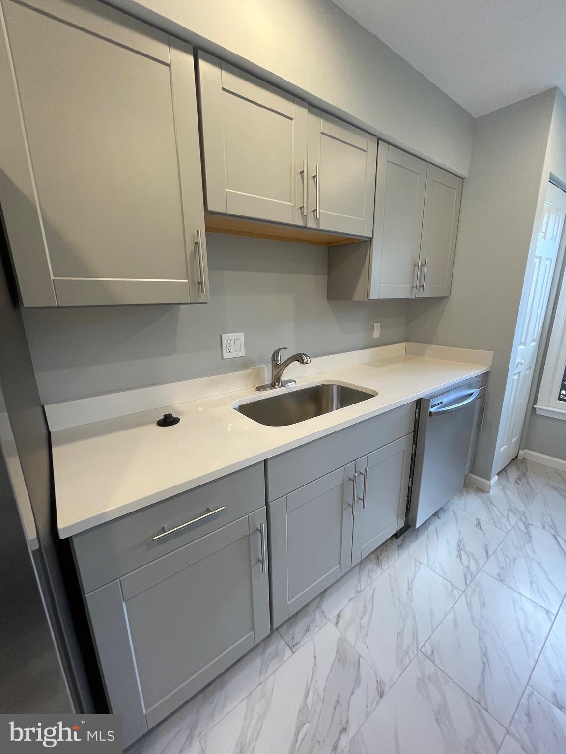 124 Andrew Place Sterling, VA 20164 - Photo 15 of 70 a kitchen with stainless steel appliances granite countertop a sink and cabinets with wooden floor