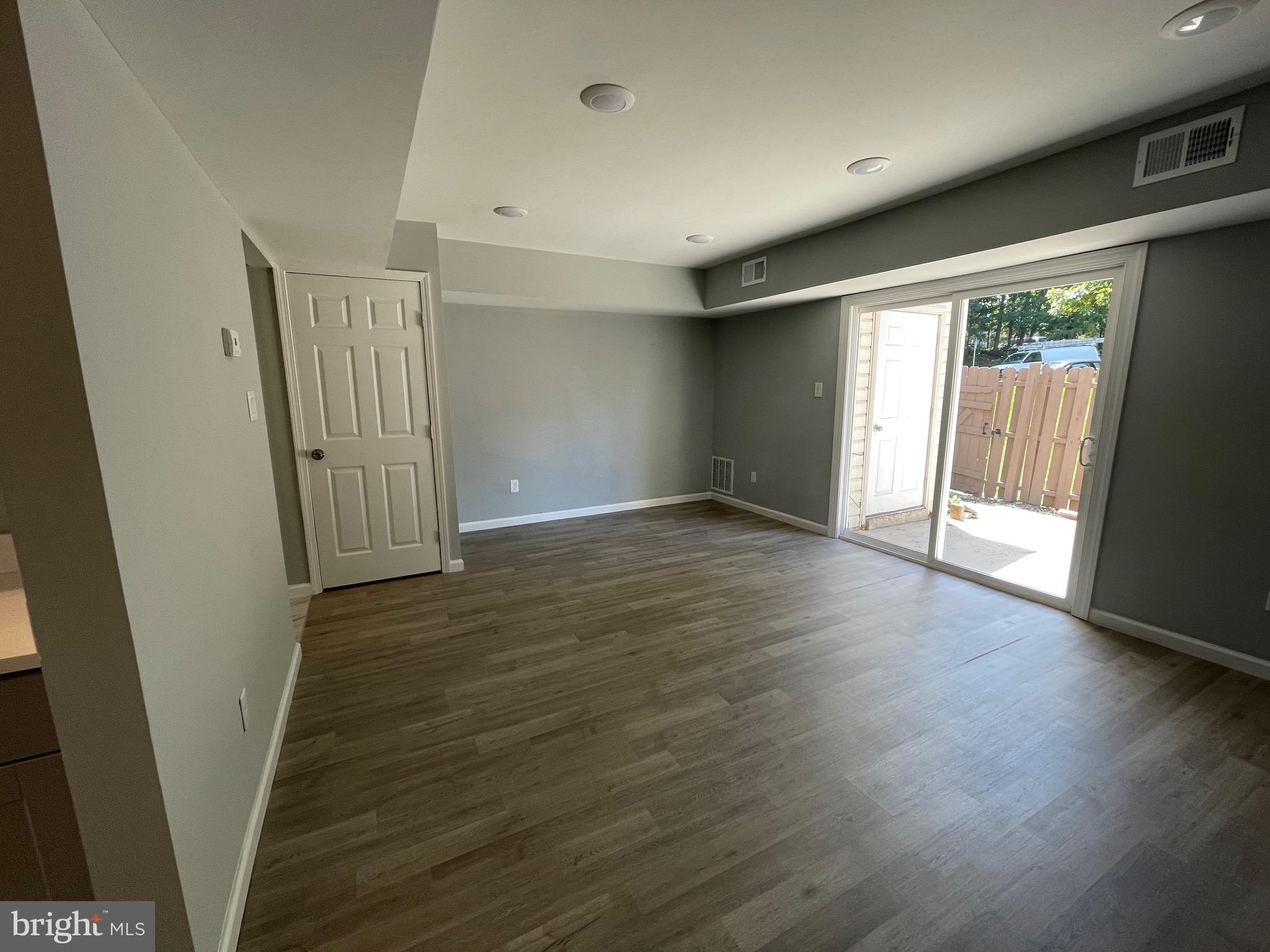 124 Andrew Place Sterling, VA 20164 - Photo 19 of 70 an empty room with wooden floor and windows