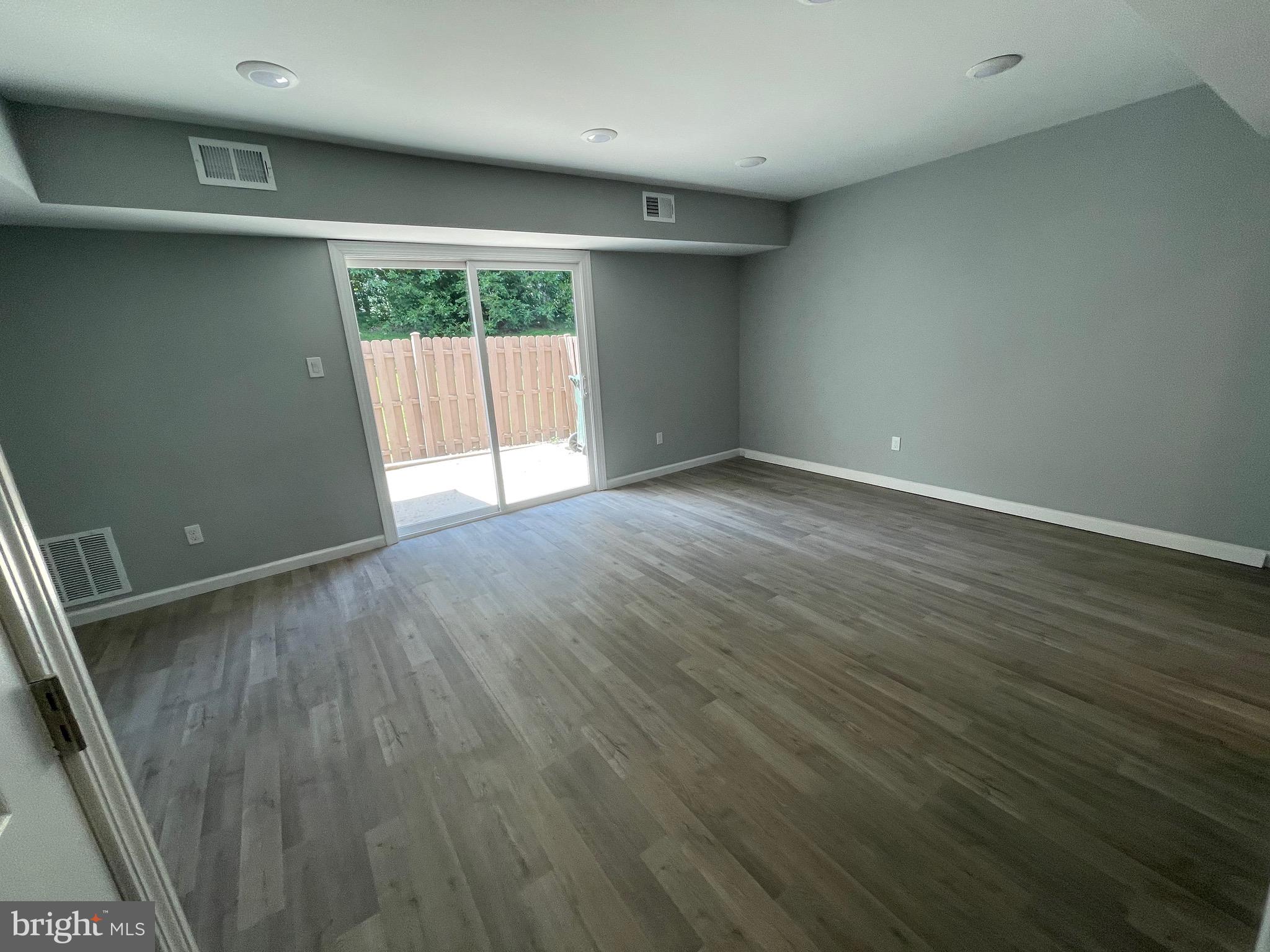 124 Andrew Place Sterling, VA 20164 - Photo 20 of 70 a view of an empty room with wooden floor and a window