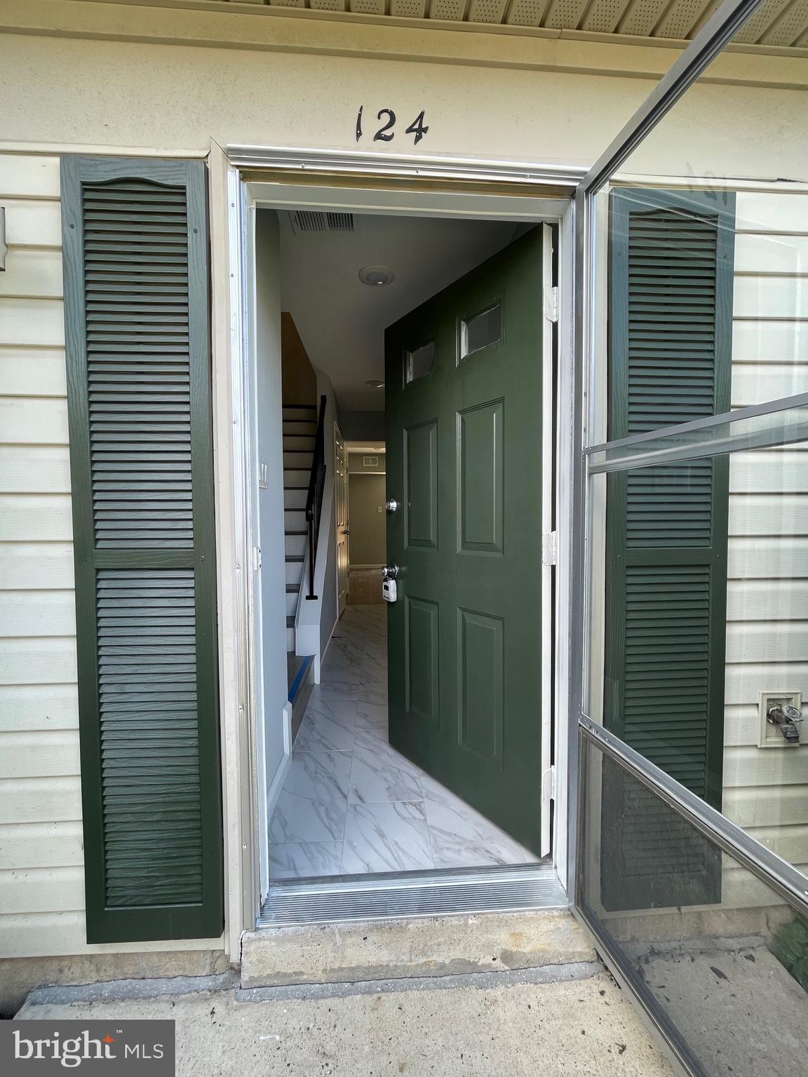 124 Andrew Place Sterling, VA 20164 - Photo 2 of 70 a view of a hallway with wooden shelves