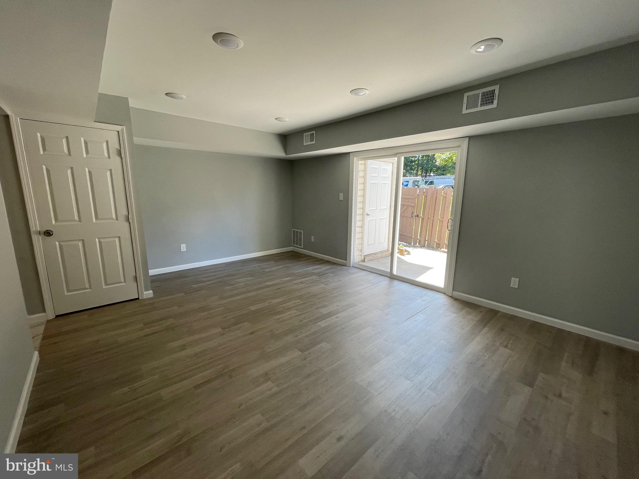 124 Andrew Place Sterling, VA 20164 - Photo 21 of 70 an empty room with wooden floor and windows