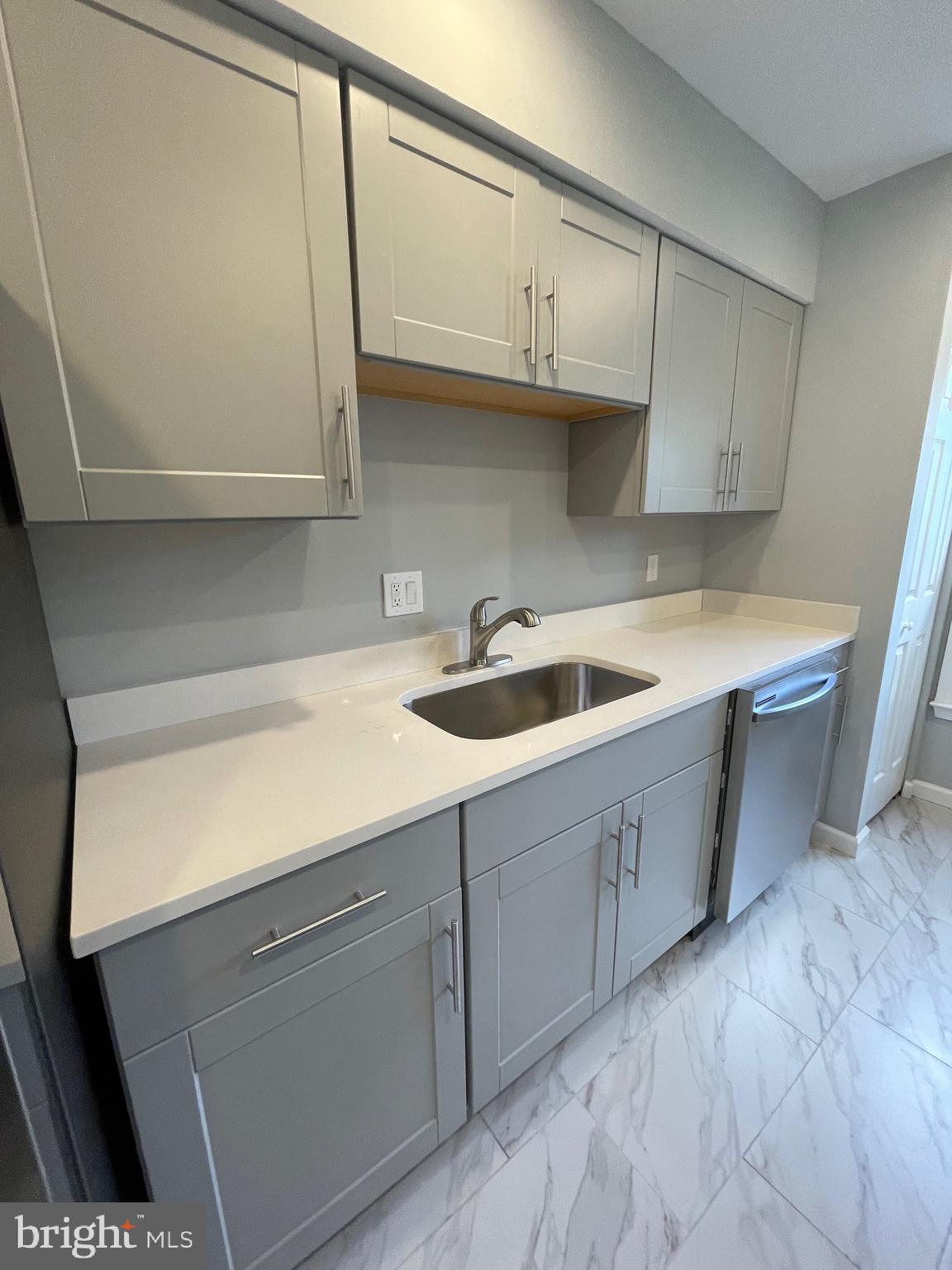 124 Andrew Place Sterling, VA 20164 - Photo 22 of 70 a kitchen with stainless steel appliances granite countertop a sink and a white cabinets