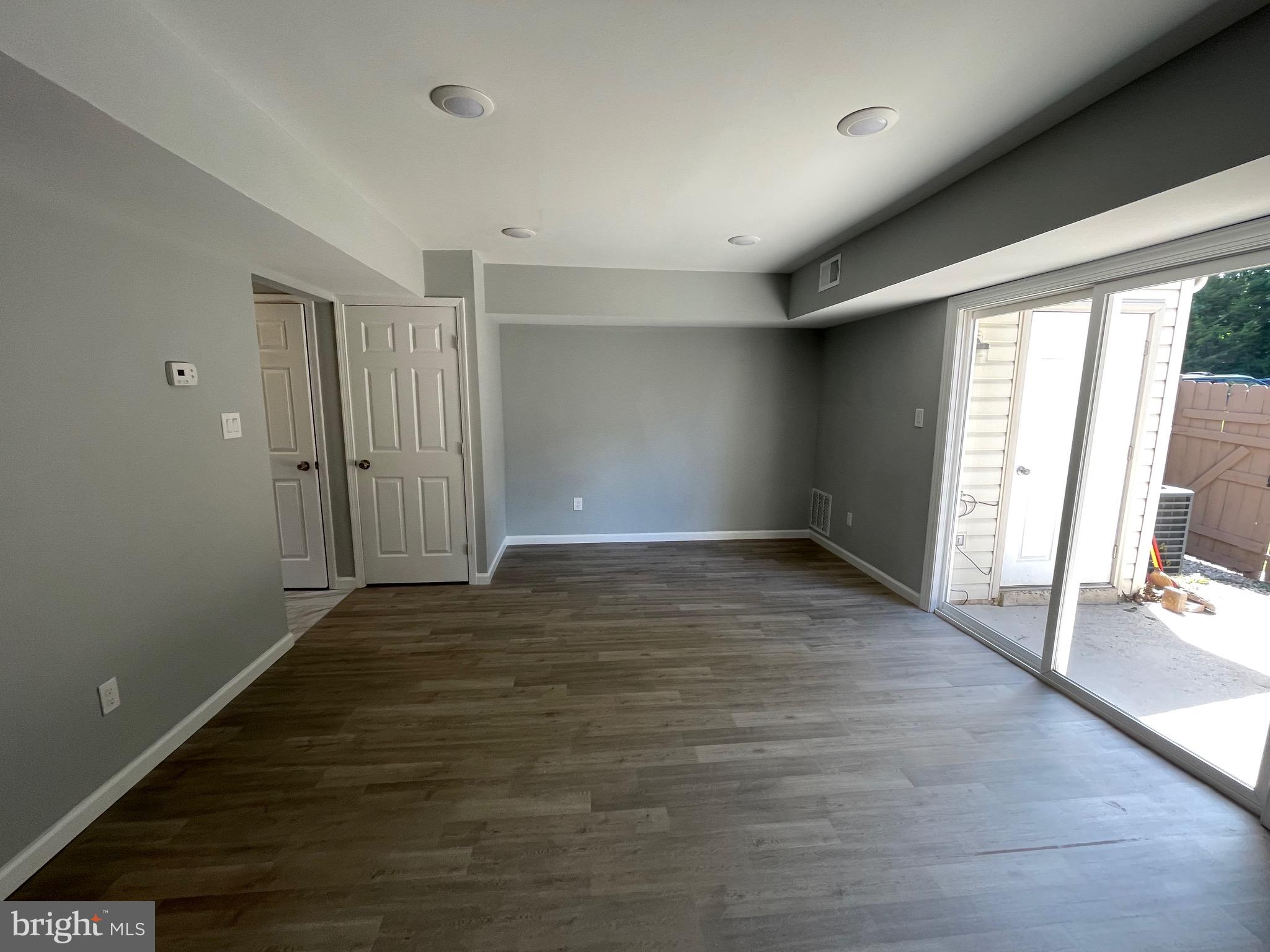 124 Andrew Place Sterling, VA 20164 - Photo 24 of 70 an empty room with wooden floor and windows