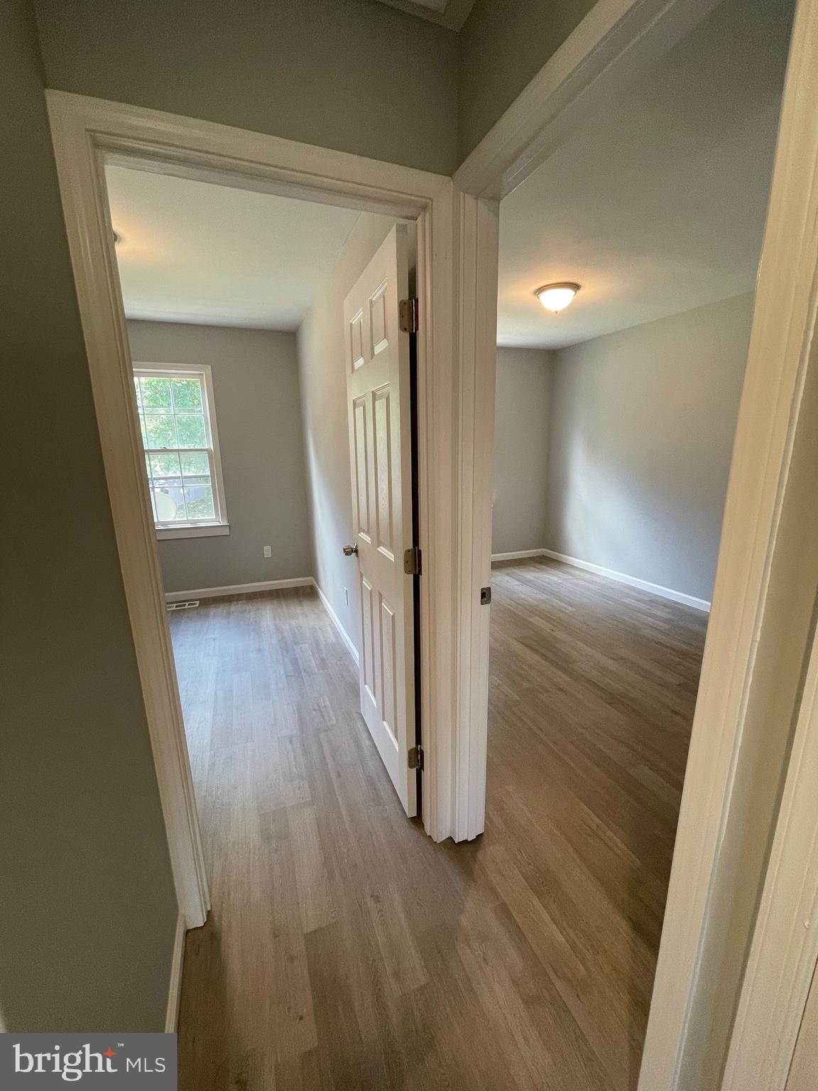 124 Andrew Place Sterling, VA 20164 - Photo 26 of 70 a view of hallway with a door and wooden floor
