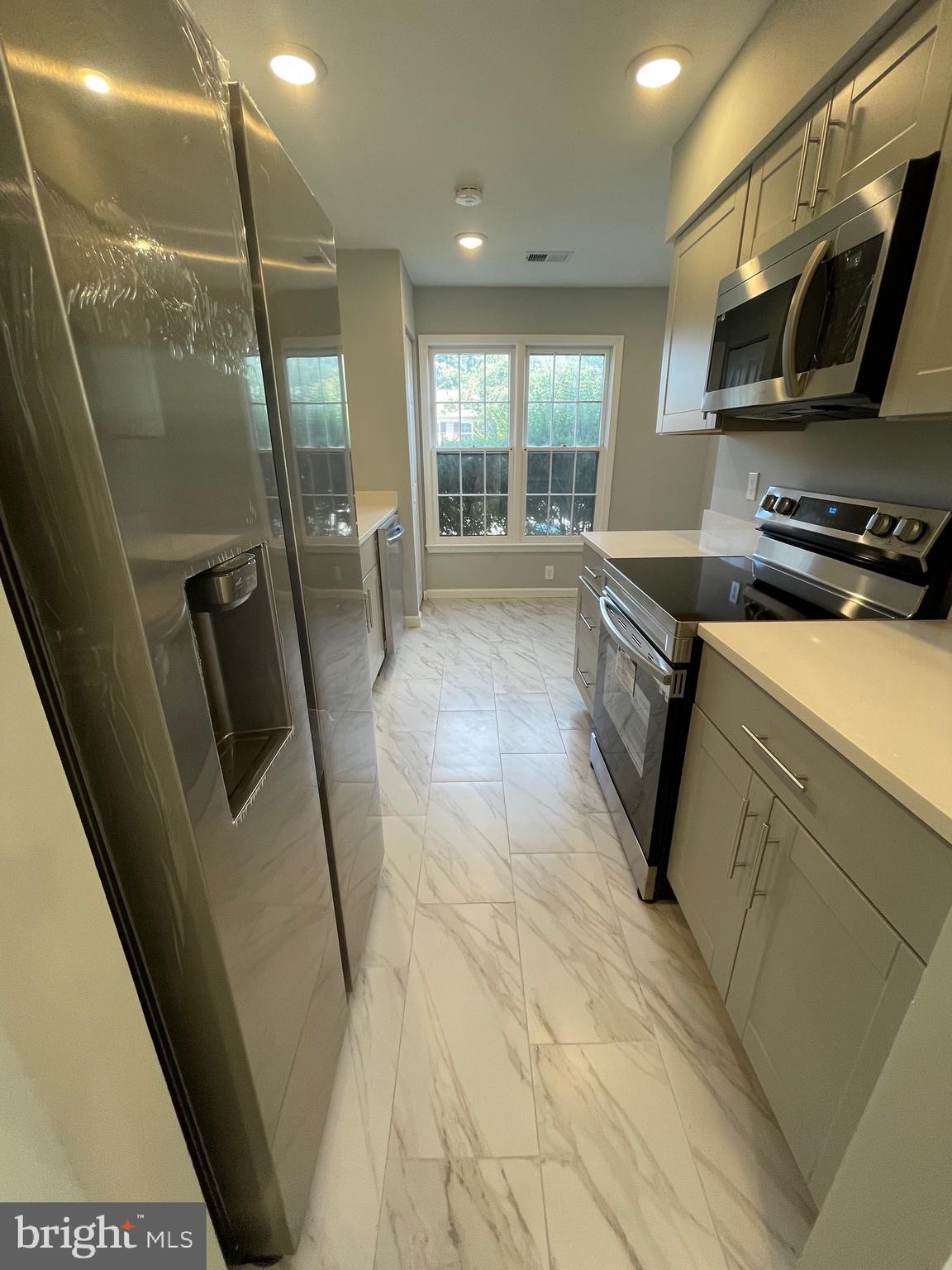 124 Andrew Place Sterling, VA 20164 - Photo 29 of 70 a kitchen with stainless steel appliances a refrigerator and a sink