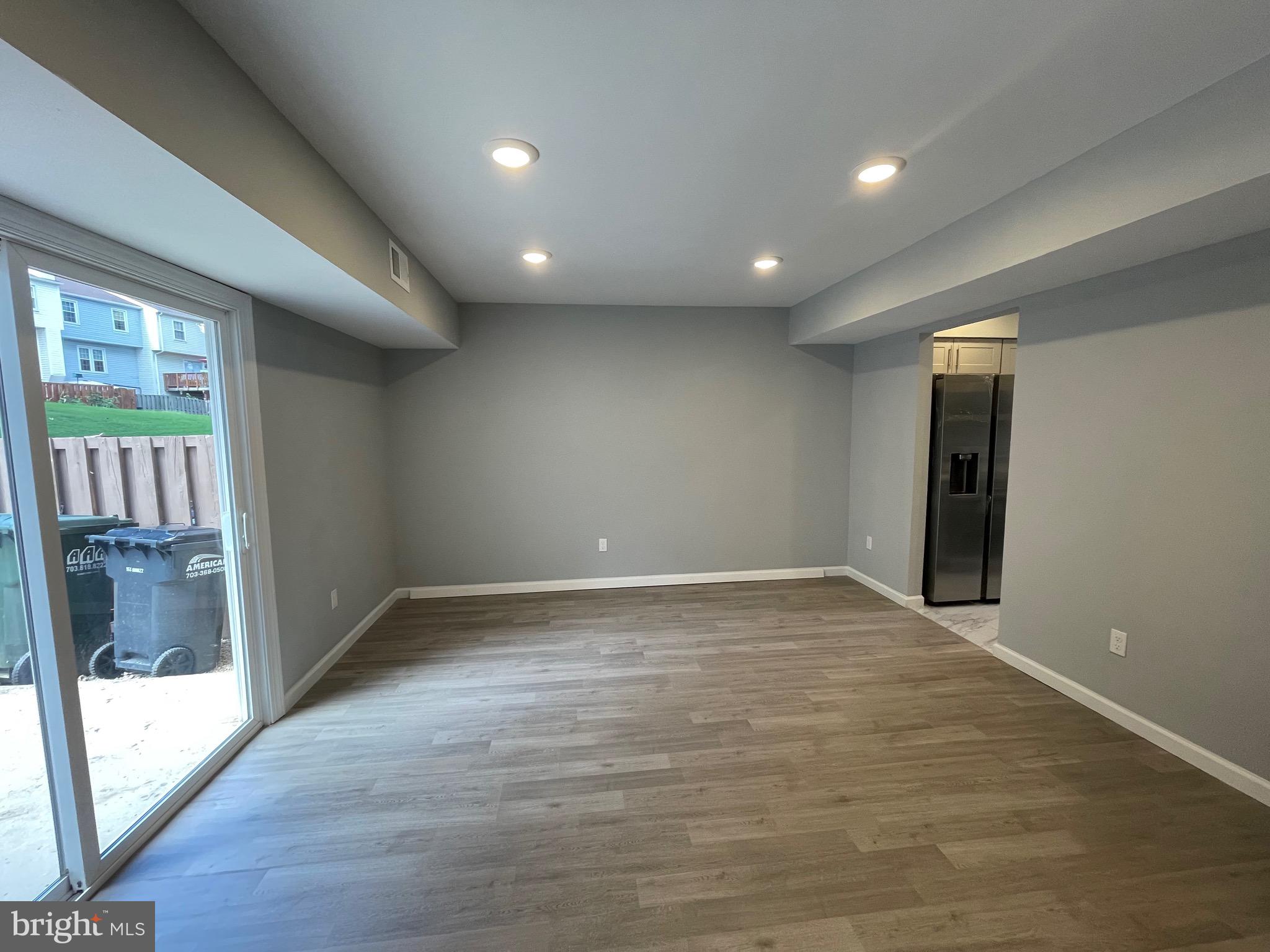 124 Andrew Place Sterling, VA 20164 - Photo 30 of 70 a view of an empty room with wooden floor and a window